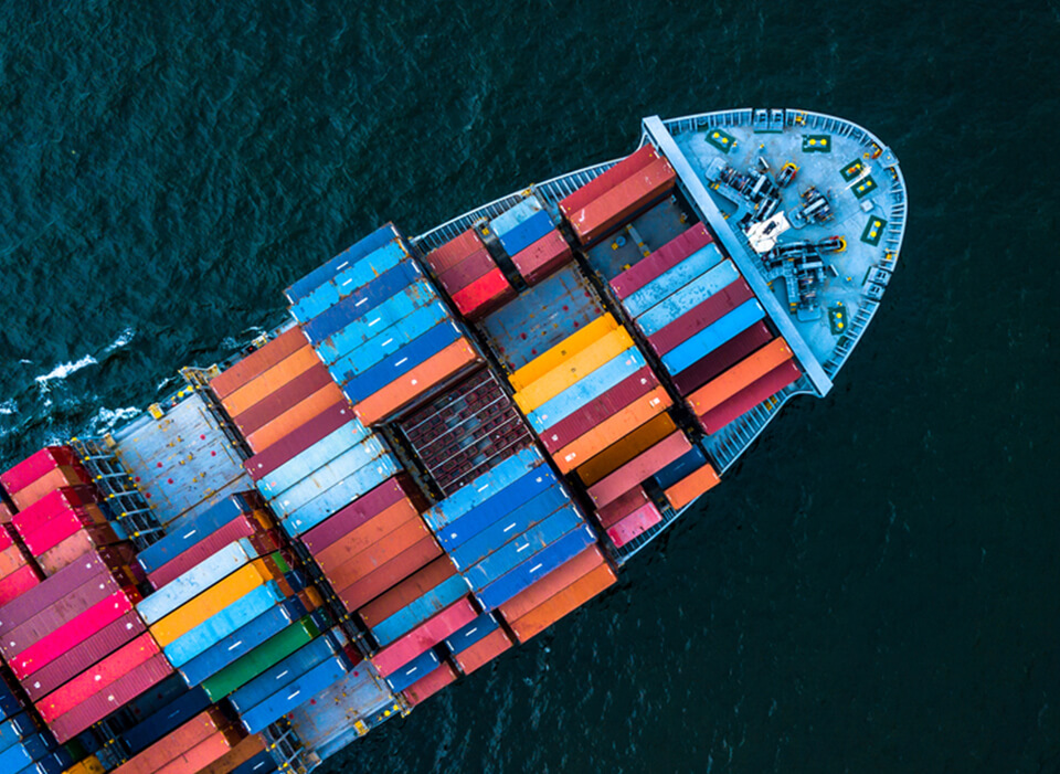 Load container into a shipping vessel